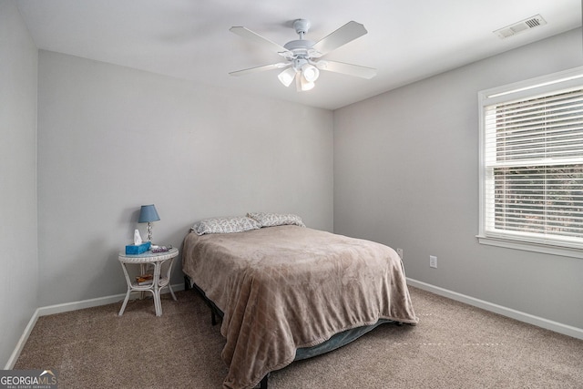 bedroom with ceiling fan, carpet floors, visible vents, and baseboards