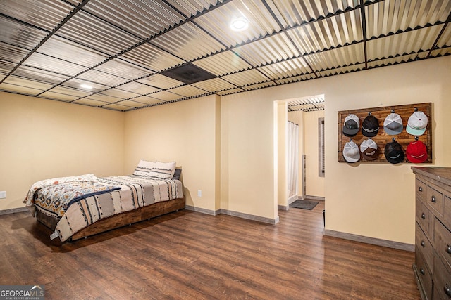 bedroom featuring baseboards and wood finished floors