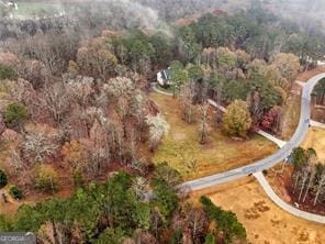 aerial view featuring a wooded view