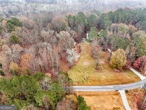 drone / aerial view with a wooded view