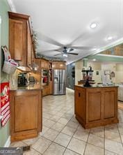 kitchen with ceiling fan, light tile patterned floors, stainless steel refrigerator with ice dispenser, and brown cabinets