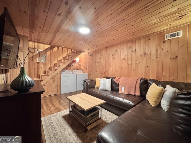 living room with visible vents, washer and clothes dryer, wooden ceiling, stairway, and wood finished floors