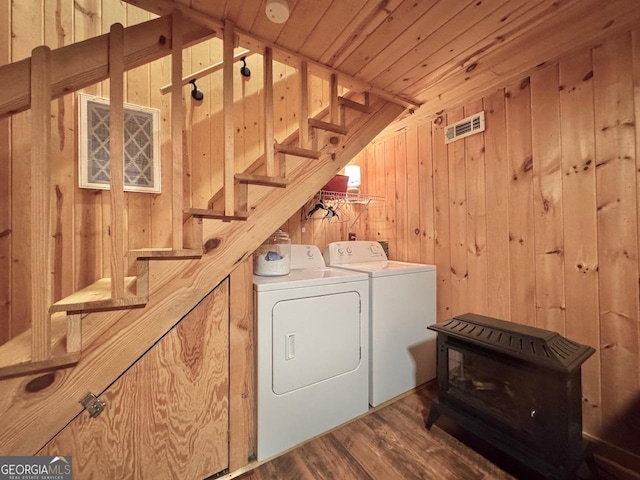 washroom with laundry area, wood ceiling, wood finished floors, independent washer and dryer, and wood walls