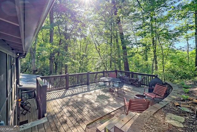 185 Pope Dickson Ln, Clarkesville, GA 30523 - wooden deck with outdoor dining space and a view of trees
