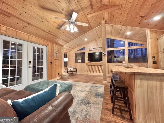 living room featuring lofted ceiling, wooden ceiling, wood finished floors, and french doors