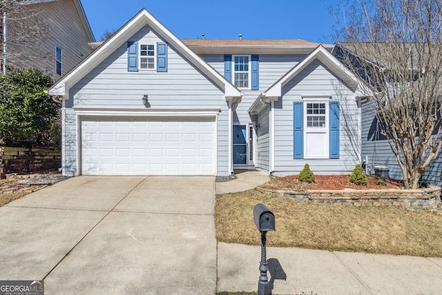 traditional-style house featuring concrete driveway and an attached garage