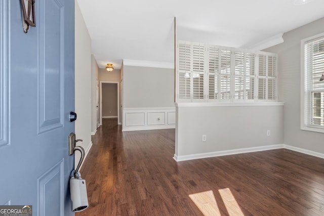 foyer entrance featuring baseboards and wood finished floors