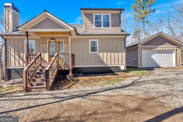1172 Hunter Dr, Ranger, GA 30734 - view of front of property with a garage, covered porch, a chimney, a shingled roof, and board and batten siding