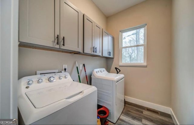 1172 Hunter Dr, Ranger, GA 30734 - laundry room with cabinet space, wood finished floors, baseboards, and washing machine and clothes dryer