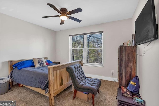 carpeted bedroom with ceiling fan and baseboards