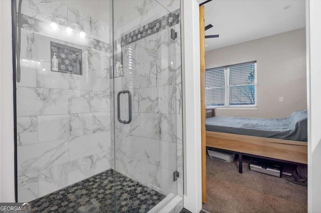 ensuite bathroom featuring a stall shower, connected bathroom, and a ceiling fan