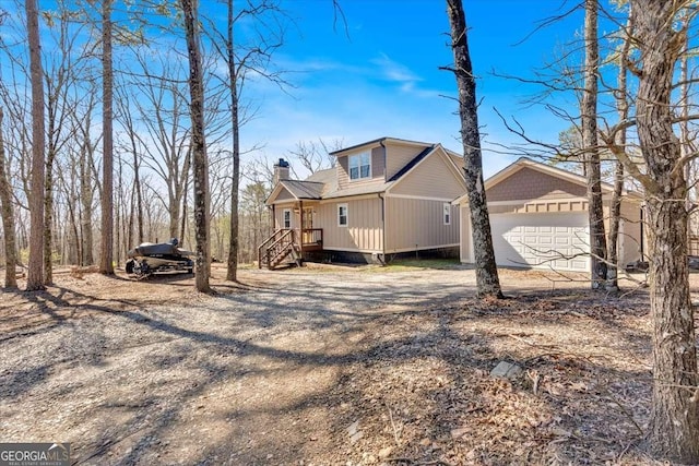 1172 Hunter Dr, Ranger, GA 30734 - view of property exterior with dirt driveway, a chimney, and an attached garage