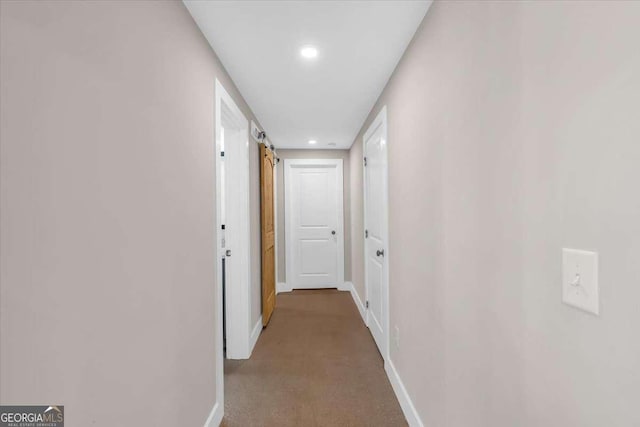 hallway featuring recessed lighting and baseboards