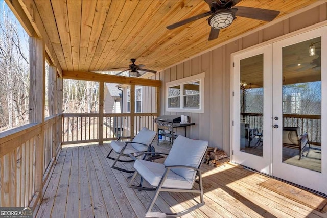 sunroom with wood ceiling, french doors, and ceiling fan