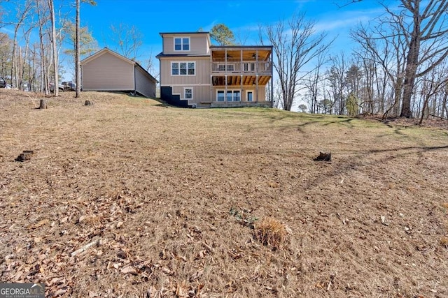 1172 Hunter Dr, Ranger, GA 30734 - rear view of property with board and batten siding, a lawn, and a balcony