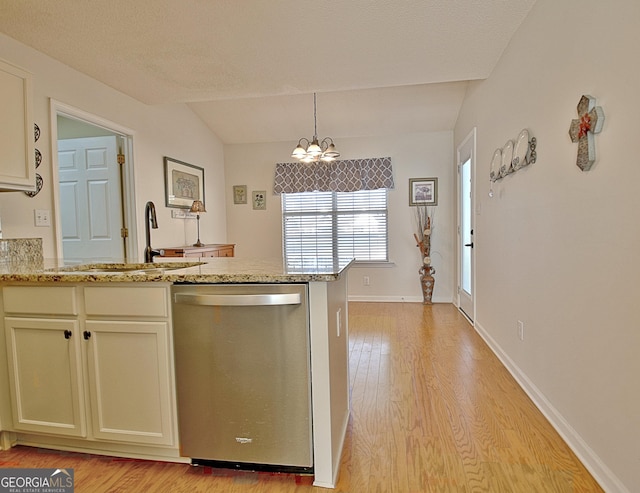 kitchen with dishwasher, light stone counters, a notable chandelier, light wood-style floors, and a sink