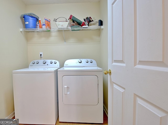 washroom featuring laundry area and washing machine and clothes dryer