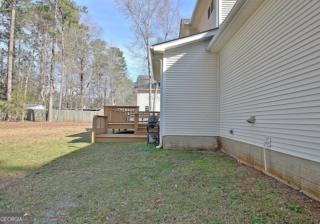 view of yard with fence and a deck