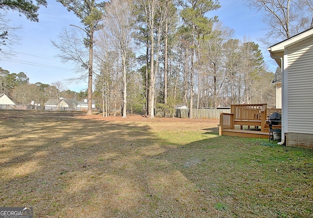 view of yard with fence and a wooden deck