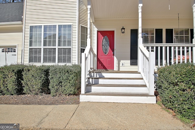 doorway to property with a shingled roof