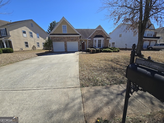 view of front of property featuring a garage, stone siding, and concrete driveway