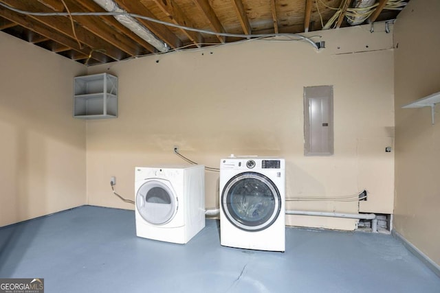 washroom with laundry area, washing machine and dryer, and electric panel