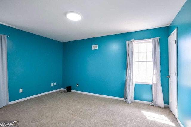 empty room with carpet flooring and baseboards