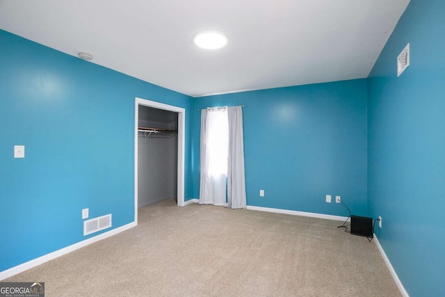 unfurnished bedroom with carpet, a closet, visible vents, and baseboards