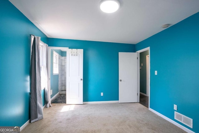 interior space featuring baseboards, visible vents, and carpet flooring