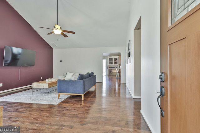 entryway featuring ceiling fan, baseboards, high vaulted ceiling, and wood finished floors