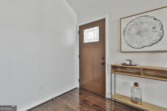 foyer featuring dark wood-type flooring and baseboards