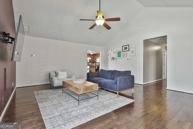 living area with hardwood / wood-style flooring, high vaulted ceiling, baseboards, and ceiling fan