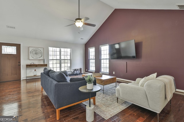 living area with hardwood / wood-style flooring, a ceiling fan, visible vents, and high vaulted ceiling