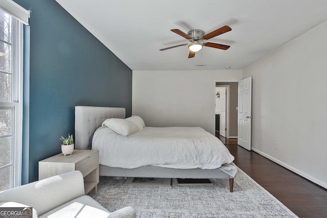 bedroom featuring ceiling fan, baseboards, and wood finished floors