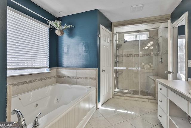 full bathroom with tile patterned floors, a jetted tub, visible vents, and a stall shower