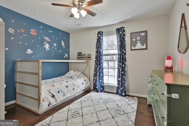 bedroom with multiple windows, wood finished floors, visible vents, and baseboards