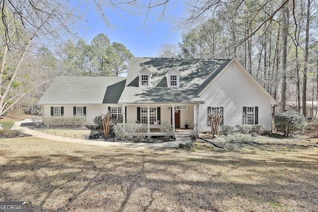 cape cod-style house with a porch and a front yard