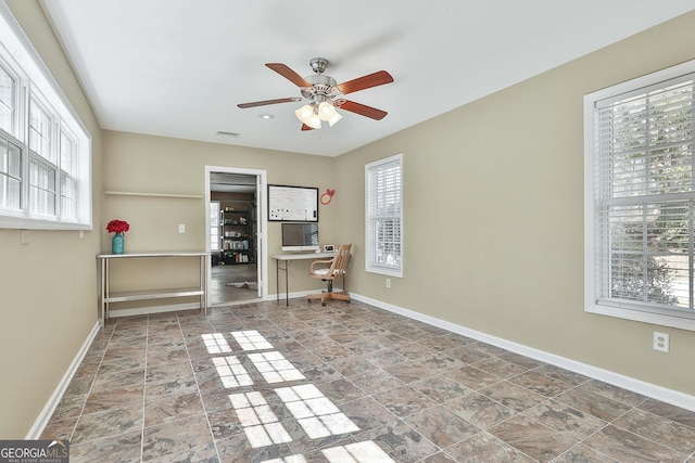 empty room featuring visible vents, baseboards, and ceiling fan