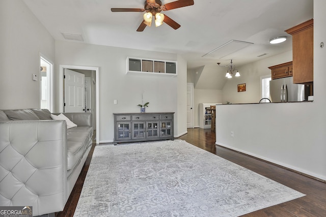 living area with dark wood finished floors, visible vents, baseboards, and ceiling fan