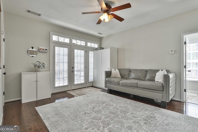 living area featuring visible vents, french doors, ceiling fan, and dark wood-style flooring