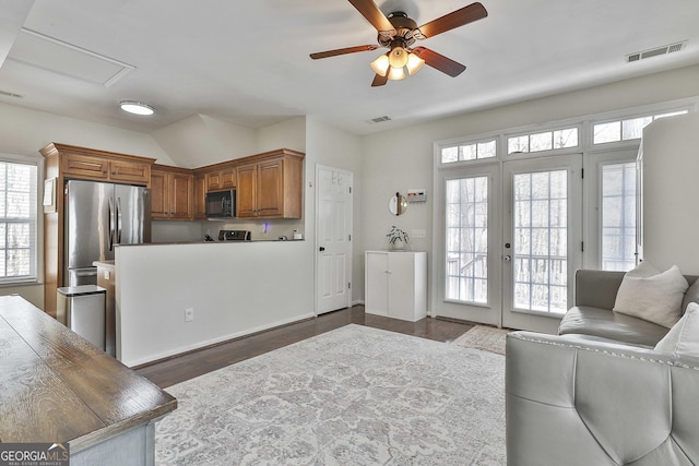 living area with visible vents, dark wood-style flooring, a ceiling fan, and french doors