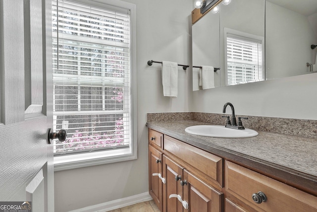 bathroom featuring vanity, tile patterned floors, and baseboards