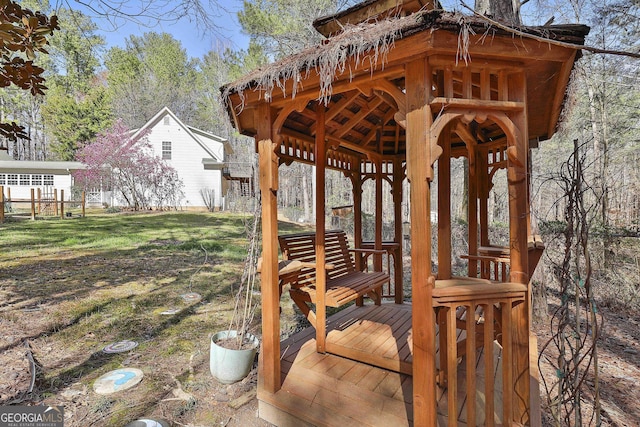 wooden deck featuring a gazebo and a yard