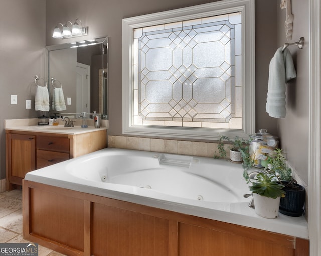 bathroom with a jetted tub and vanity