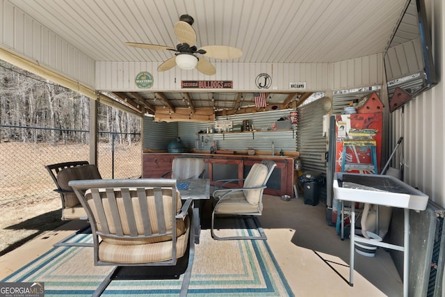 view of patio / terrace featuring ceiling fan, outdoor dining space, and fence