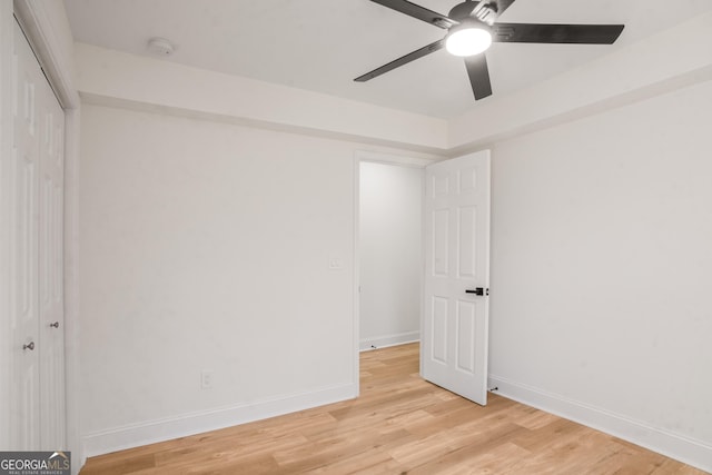 interior space featuring light wood-style flooring, baseboards, and a ceiling fan