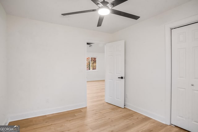 unfurnished bedroom with light wood finished floors, a closet, and baseboards