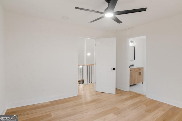 unfurnished bedroom featuring light wood finished floors, ceiling fan, baseboards, and connected bathroom