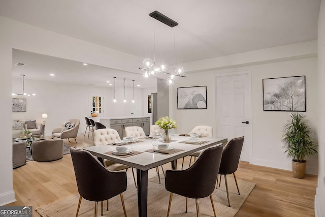 dining area featuring recessed lighting, visible vents, a notable chandelier, and light wood finished floors