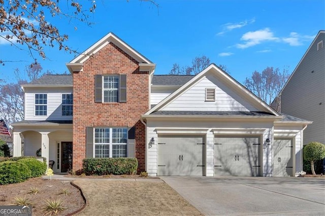 traditional home featuring a garage, concrete driveway, and brick siding